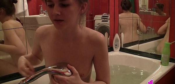  Teen plays with herself in the bathtub
